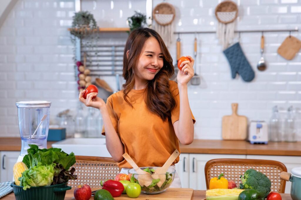 beautiful young woman happy portrait cooking fresh organic clean food fruit at home modern kitchen 2
