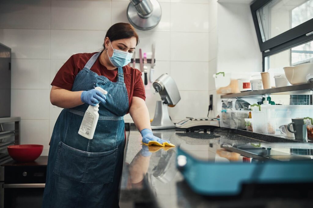 kitchen personnel responsible for cleaning and sanitizing highly touched surfaces
